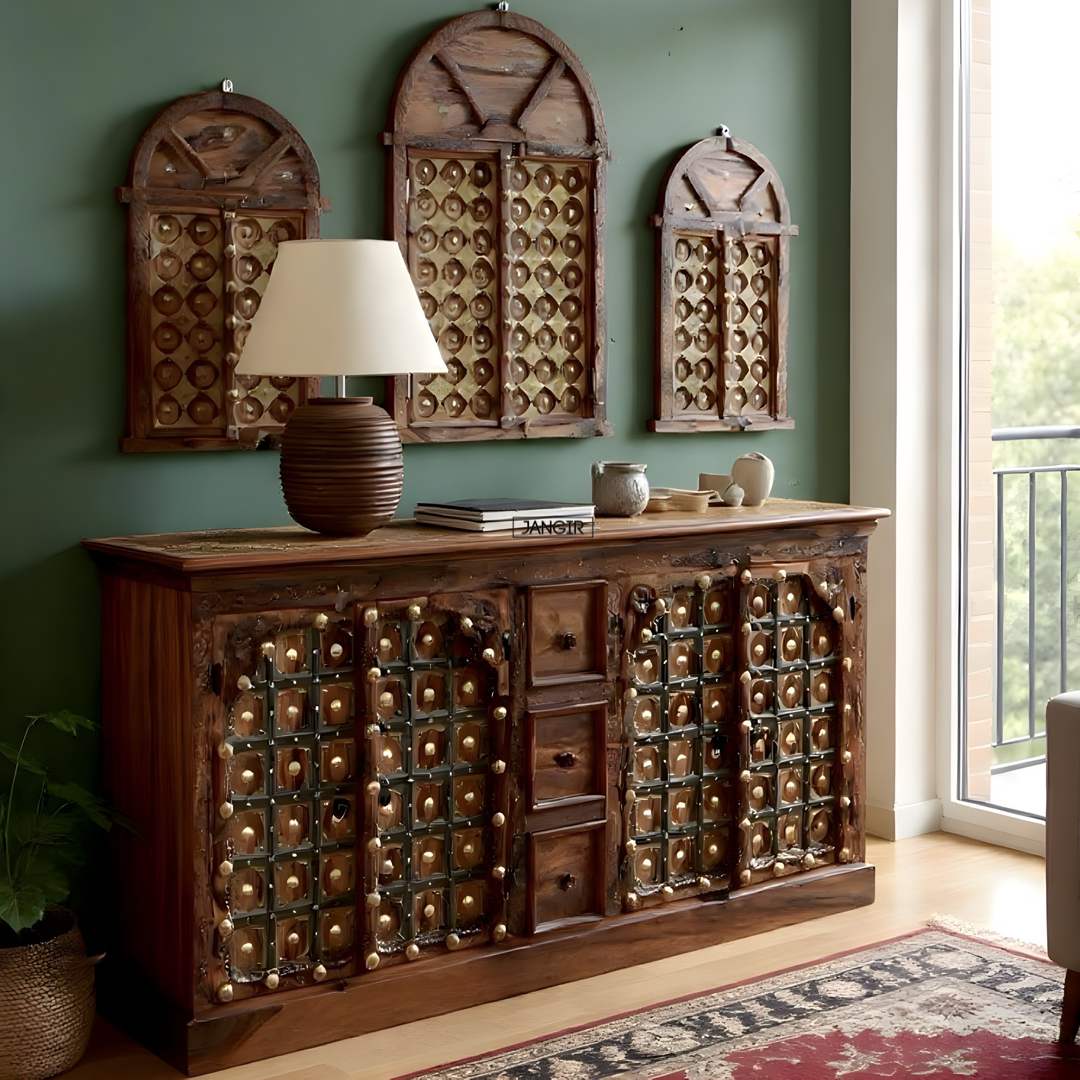 Wooden sideboard with decorative elements against a green wall