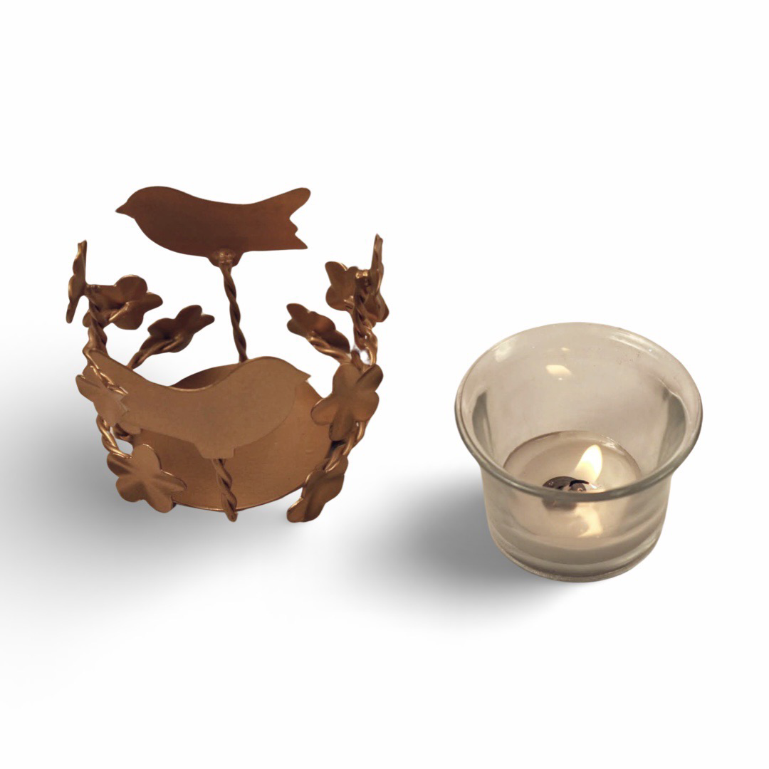 Tea Light Holder - Discover the exquisite  Tea Light Holder Crafted from metal this chic bird-themed tea light holder embodies elegance and warmth. Elevate any space with unscented tealights, Buy now