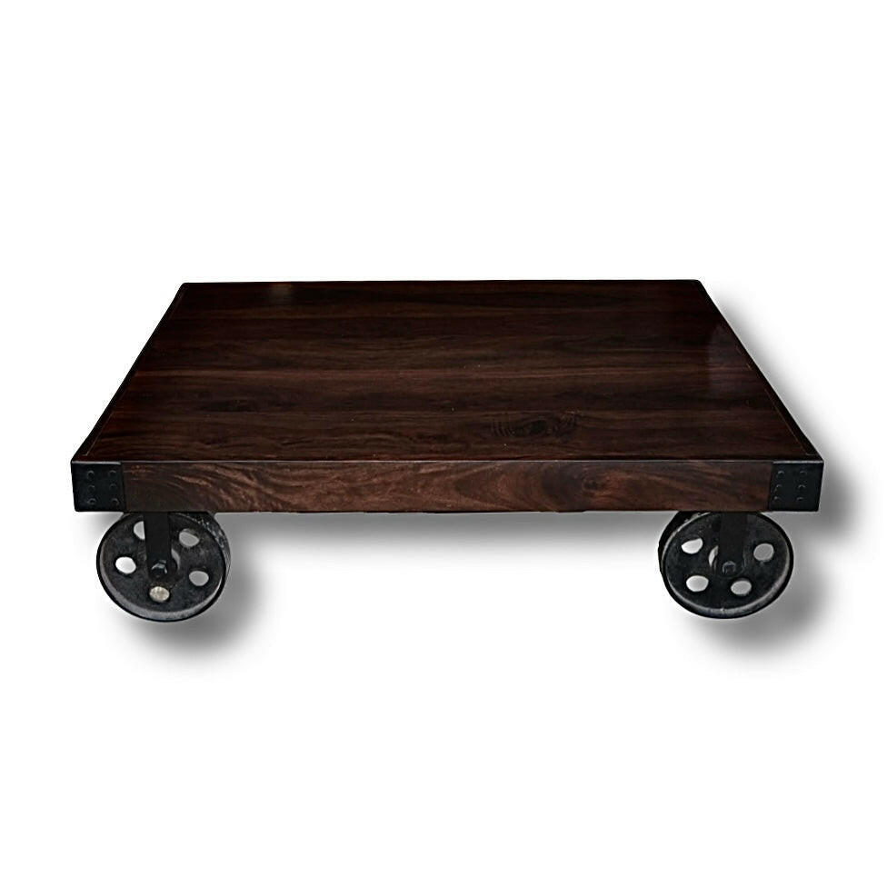 Enhance your living space with our stylish industrial coffee table with wheels, crafted from Sheesham wood and accented by sturdy metal wheel legs. Explore now for a touch of rustic charm!